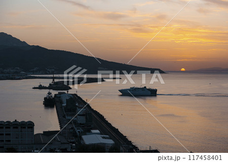 View of a ferry at sunset entering the port of Ceuta 117458401