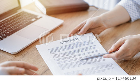 Businesswoman lawyer pointing into contract special points admitting something for colleague or client at the wooden desk in office. Business people teamwork and partnership, meeting concept Businesswoman lawyer pointing into contract special points admitting something for colleague or client at the wooden desk in office. Business people teamwork and partnership, meeting concept 117460134