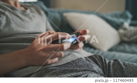 Close up hands of Caucasian young boy playing video game using wireless controller Close up hands of Caucasian young boy playing video game using wireless controller 117460493