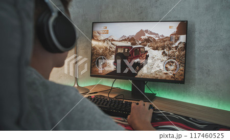 Caucasian teen enjoys gameplay in off road racing simulator 117460525