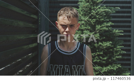 Caucasian teen boy with wet face, hair and clothes looking at camera 117460536