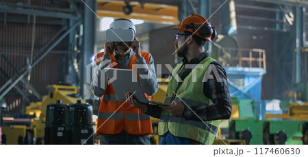 Mature engineer uses VR headset, adult employee work in laptop 117460630