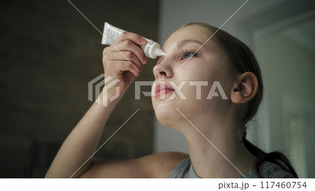Pretty girl with perfect soft face stands in front of sink Pretty girl with perfect soft face stands in front of sink 117460754