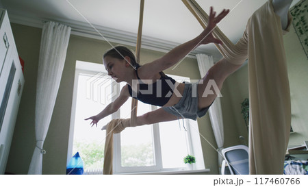 Young girl records on phone her exercises in air gymnastic Young girl records on phone her exercises in air gymnastic 117460766