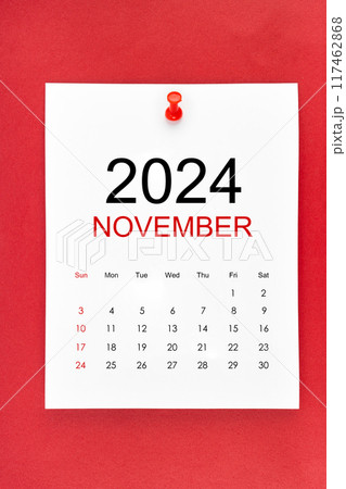 November 2024 calendar page with push pin on red background. 117462868