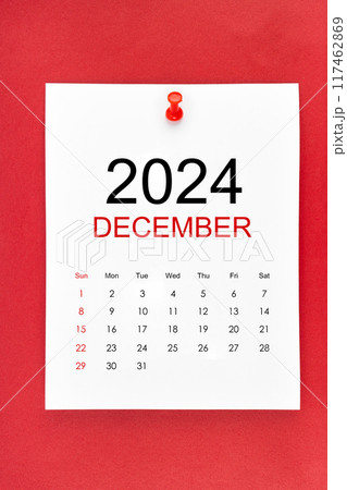 December 2024 calendar page with push pin on red background. December 2024 calendar page with push pin on red background. 117462869