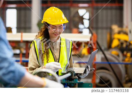 engineer female using laptop working in manufacturing factory. 117463138