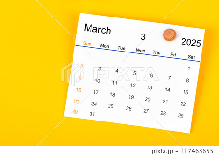 March 2025 and wooden push pin on yellow. March 2025 and wooden push pin on yellow. 117463655