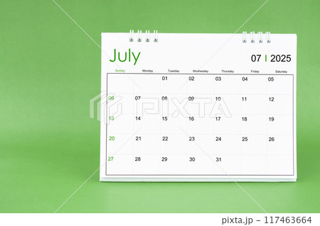 July 2025 desk calendar isolated in green background. July 2025 desk calendar isolated in green background. 117463664