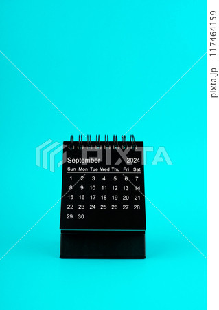 Black Calendar for September 2024. Desktop calendar on a green background. 117464159