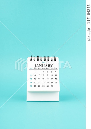 January 2025 white desk calendar on blue background. January 2025 white desk calendar on blue background. 117464258