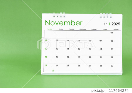 November 2025 desk calendar isolated in green background. 117464274