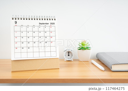 September 2025, Monthly desk calendar for 2025 year on wooden table. 117464275