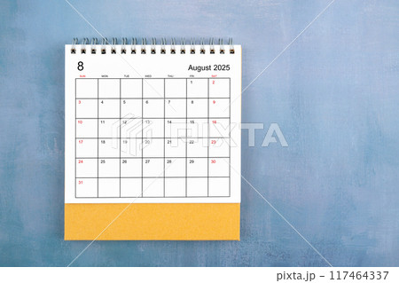 Directly above view of August 2025 desk calendar on blue wooden background. 117464337