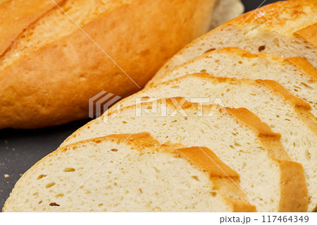 Golden, freshly sliced loaf of homemade bread, perfect for sandwiches, breakfast, or toasting Golden, freshly sliced loaf of homemade bread, perfect for sandwiches, breakfast, or toasting 117464349