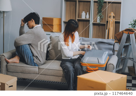 Offended couple ignoring each other after quarrel indoors, selective focus. Relationship problems 117464640