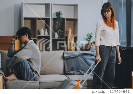 Offended couple ignoring each other after quarrel indoors, selective focus. Relationship problems 117464641