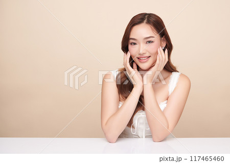 Beautiful young asian woman with clean fresh skin on beige background, Face care, Facial treatment, Cosmetology, beauty and spa, Asian women portrait. 117465460