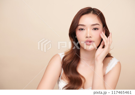 Beautiful young asian woman with clean fresh skin on beige background, Face care, Facial treatment, Cosmetology, beauty and spa, Asian women portrait. 117465461