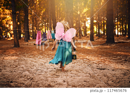 Back, walking and child in forest, girl and wings of butterfly, lantern and journey in morning. Fairytale, kid and travel in woods, trees and nature of California, summer and adventure of outdoor Back, walking and child in forest, girl and wings of butterfly, lantern and journey in morning. Fairytale, kid and travel in woods, trees and nature of California, summer and adventure of outdoor 117465676