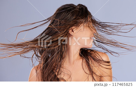Woman, shake and wet hair in studio for beauty, keratin treatment and cosmetics on blue background. Female person, haircare and textures for dermatology, grooming and conditioner for growth or clean 117465825
