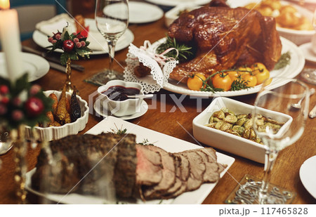 Vacation dinner, home or table with roast beef for Christmas meal, cut meat or luxury cooking in house. Holiday, kitchen or grill steak for protein with festive season, party with food for wellness Vacation dinner, home or table with roast beef for Christmas meal, cut meat or luxury cooking in house. Holiday, kitchen or grill steak for protein with festive season, party with food for wellness 117465828