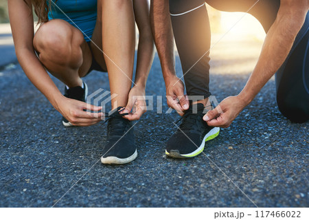 Outside, hands and tie shoes in road ready for fitness, exercise and training for wellness or health. Couple, sneakers and people fixing lace on ground, nature or before running for sports challenge 117466022