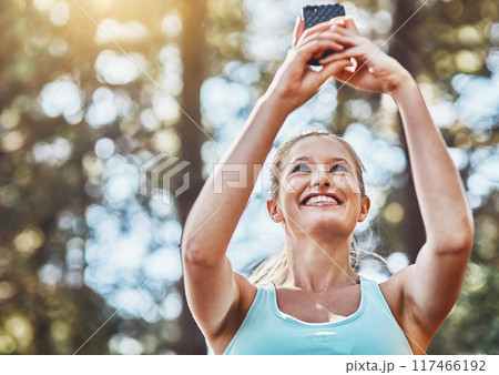 Woman, nature and runner or exercise selfie, workout app and training in woods for fitness routine. Female person, cardio website and athlete for wellness or exercise, forest path and social media 117466192