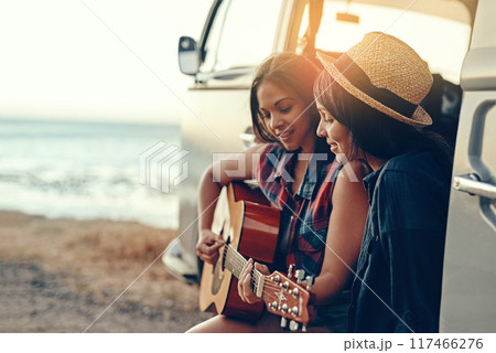 Van, road trip and women at a beach with guitar for sunset, adventure and music while bonding on vacation in nature. Caravan, travel or friends at sea with acoustic instrument, song or fun in Mexico Van, road trip and women at a beach with guitar for sunset, adventure and music while bonding on vacation in nature. Caravan, travel or friends at sea with acoustic instrument, song or fun in Mexico 117466276