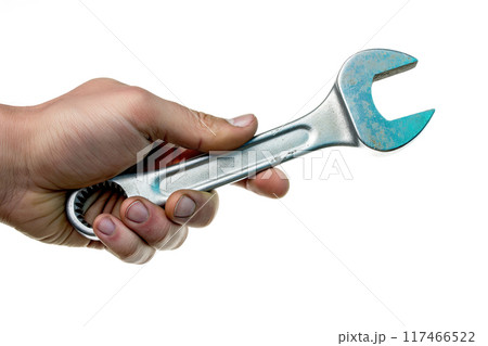 Hand holding a spanner isolated on white background 117466522