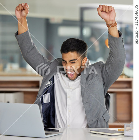 Businessman, celebrate and office with laptop at desk with success for good news in business. Stock market, winner and tech in finance company with investment for growth with promotion in career Businessman, celebrate and office with laptop at desk with success for good news in business. Stock market, winner and tech in finance company with investment for growth with promotion in career 117466635