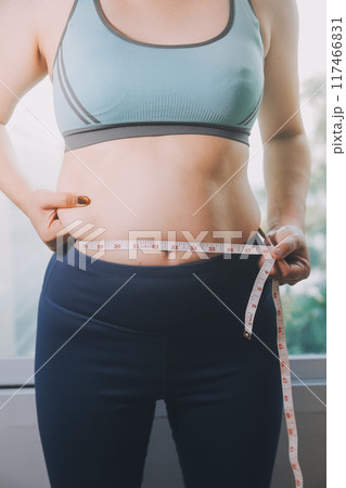 fat woman, fat belly, chubby, obese woman hand holding excessive belly fat with measure tape, woman diet lifestyle concept fat woman, fat belly, chubby, obese woman hand holding excessive belly fat with measure tape, woman diet lifestyle concept 117466831