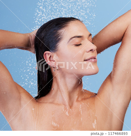 Shower, water and woman washing hair for shampoo, cosmetics and wellness cleaning or conditioner. Female person, happy and rinsing scalp in studio blue background for skin care or morning routine Shower, water and woman washing hair for shampoo, cosmetics and wellness cleaning or conditioner. Female person, happy and rinsing scalp in studio blue background for skin care or morning routine 117466893