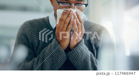 Man, sick and sneezing with tissue in hand, healthcare and influenza cold or covid virus for wellness risk in office. Sinus symptoms, allergy problem and seasonal change, hay fever and unwell person Man, sick and sneezing with tissue in hand, healthcare and influenza cold or covid virus for wellness risk in office. Sinus symptoms, allergy problem and seasonal change, hay fever and unwell person 117466947
