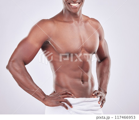 Abdomen, muscle and African man for fitness with towel, exercise and cleaning in studio. Male bodybuilder, strong body and torso with abs for wellness or health and hygiene by white background Abdomen, muscle and African man for fitness with towel, exercise and cleaning in studio. Male bodybuilder, strong body and torso with abs for wellness or health and hygiene by white background 117466953