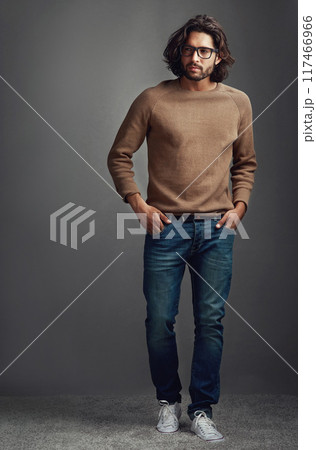 Thinking, serious man and fashion for portrait in studio, ideas for elegant style of comfortable jeans clothes. Serious, male person and trendy jersey, glasses or hands in pocket on grey background Thinking, serious man and fashion for portrait in studio, ideas for elegant style of comfortable jeans clothes. Serious, male person and trendy jersey, glasses or hands in pocket on grey background 117466966