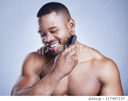 Black man, beard comb and grooming in studio, confident and haircare on blue background. Male person, brushing and maintenance for hygiene routine or cleaning, beauty and hair treatment for cosmetics 117467137
