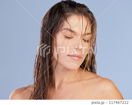 Beauty, wet hair and woman in studio with makeup for wellness, glowing skin and waterproof cosmetic results. Haircare, natural and girl model with treatment, fresh or self care on blue background. Beauty, wet hair and woman in studio with makeup for wellness, glowing skin and waterproof cosmetic results. Haircare, natural and girl model with treatment, fresh or self care on blue background. 117467222