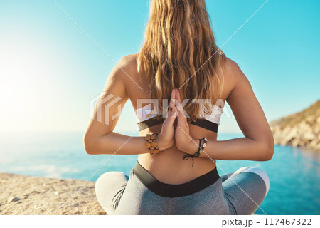 Beach, prayer hands and back of woman for yoga, wellness and spiritual peace in California. Chakra, female yogi and namaste with meditation for wellbeing, relaxing and mental health by ocean outdoor 117467322