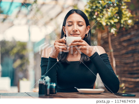 Beautiful, happy and relaxed woman smelling fresh coffee and enjoying a morning in cafe. Calm, zen and content student drinking a warm, hot and comforting cup of beverage drink in relaxing restaurant 117467459