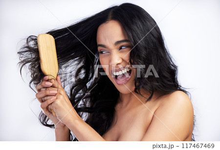 Woman, angry and brush in studio for grooming, cleaning and tangled on white background. Female person, cosmetics and tool for self care in routine, frustrated and damaged textures for treatment Woman, angry and brush in studio for grooming, cleaning and tangled on white background. Female person, cosmetics and tool for self care in routine, frustrated and damaged textures for treatment 117467469