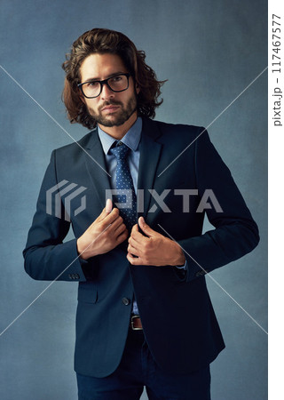 Fashion, portrait and suit with business man in studio on gray wall background for professional career. Corporate, formal jacket and style with smart employee or in work outfit for elegance or power 117467577