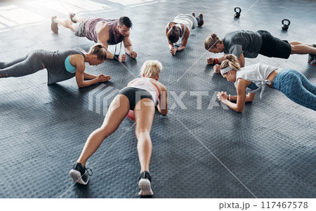 Group, fitness class and exercise with push ups in gym for arm strength, healthy body and abs workout in circle. Training collaboration, people and muscle challenge for core, weight loss and top view 117467578
