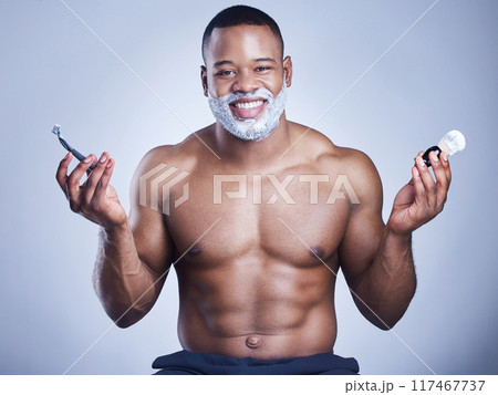 Black man, portrait and apply shaving foam in studio, beauty and grooming routine for hair removal. Brush, cream and hygiene or facial treatment for skincare, cleaning and razor on blue background Black man, portrait and apply shaving foam in studio, beauty and grooming routine for hair removal. Brush, cream and hygiene or facial treatment for skincare, cleaning and razor on blue background 117467737