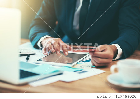 Businessman, hands and credit card for finance on tablet in office for payment, digital purchase or banking investment. Financial employee, fintech and stock market trading with startup loan at desk 117468026