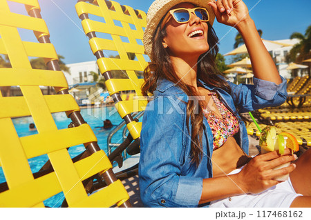Vacation, pool and woman sitting on chair for relax in sunshine, cocktail at hotel in summer. Female person, holiday or wellness in Mauritius with happiness for travel, sunglasses on tropical island 117468162