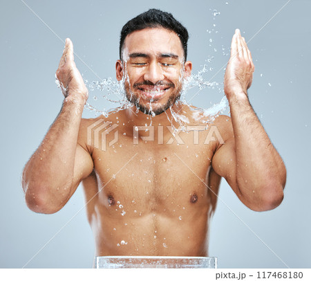 Cosmetics, man and washing face for hygiene, grooming and self care or cleaning studio grey background. Wellness, male person and water with soap showering for body health and dermatology treatment Cosmetics, man and washing face for hygiene, grooming and self care or cleaning studio grey background. Wellness, male person and water with soap showering for body health and dermatology treatment 117468180