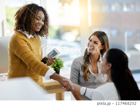 Team, business women and shaking hands for deal, partnership or b2b collaboration opportunity. Tablet, handshake and happy group of people together for introduction, thank you and welcome to startup 117468252