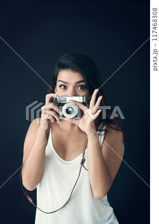 Photographer, woman and studio for creative person, photography for memories on dark background. Face, vintage equipment and photo journalist or paparazzi, photoshoot and professional with camera 117468308