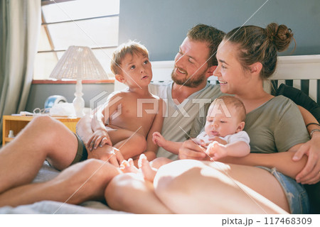 Dad, mom and kids in bed at home for relax, rest and bonding together as family. Happy people, parents or children in bedroom for love with communication, support or security in apartment with smile 117468309